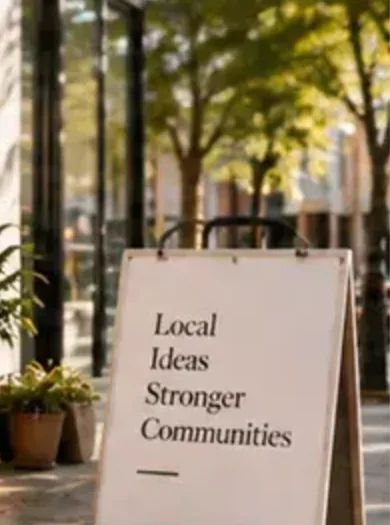 A shopfront with a sandwich board reading Local Ideas, Stronger Communities
